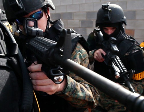 two-caucasian-male-swat-team-members-pointing-service-weapons