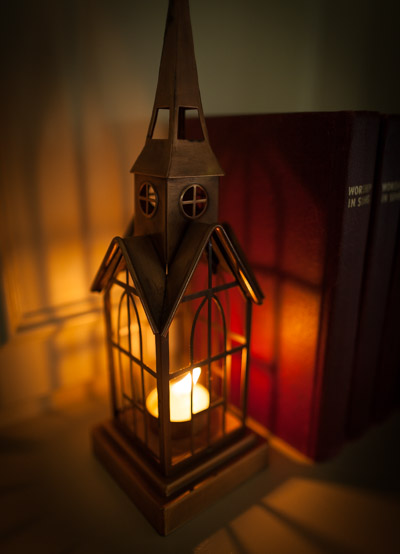 candle-inside-of-metal-bars-in-shape-of-church