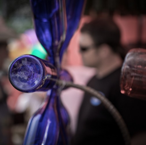 blue-glass-chandelier-with-j-tedder-in-background-wearing-black-shirt-and-sunglasses
