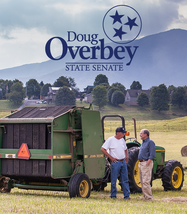 Doug Overbey-is-a-caucasian-mid-50s-male-with-a-caucasian-mid-60s-male-beisde-tractor-on-farm-land-with-campaign-logo-at-top-of-screen