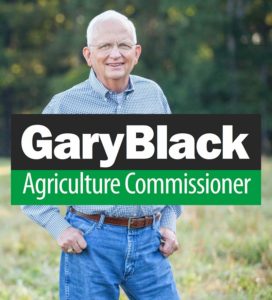 gary-black-caucasian-mid-60s-male-with-William-Dairy-caucasian-male-mid-40s-and-campaign-sign.