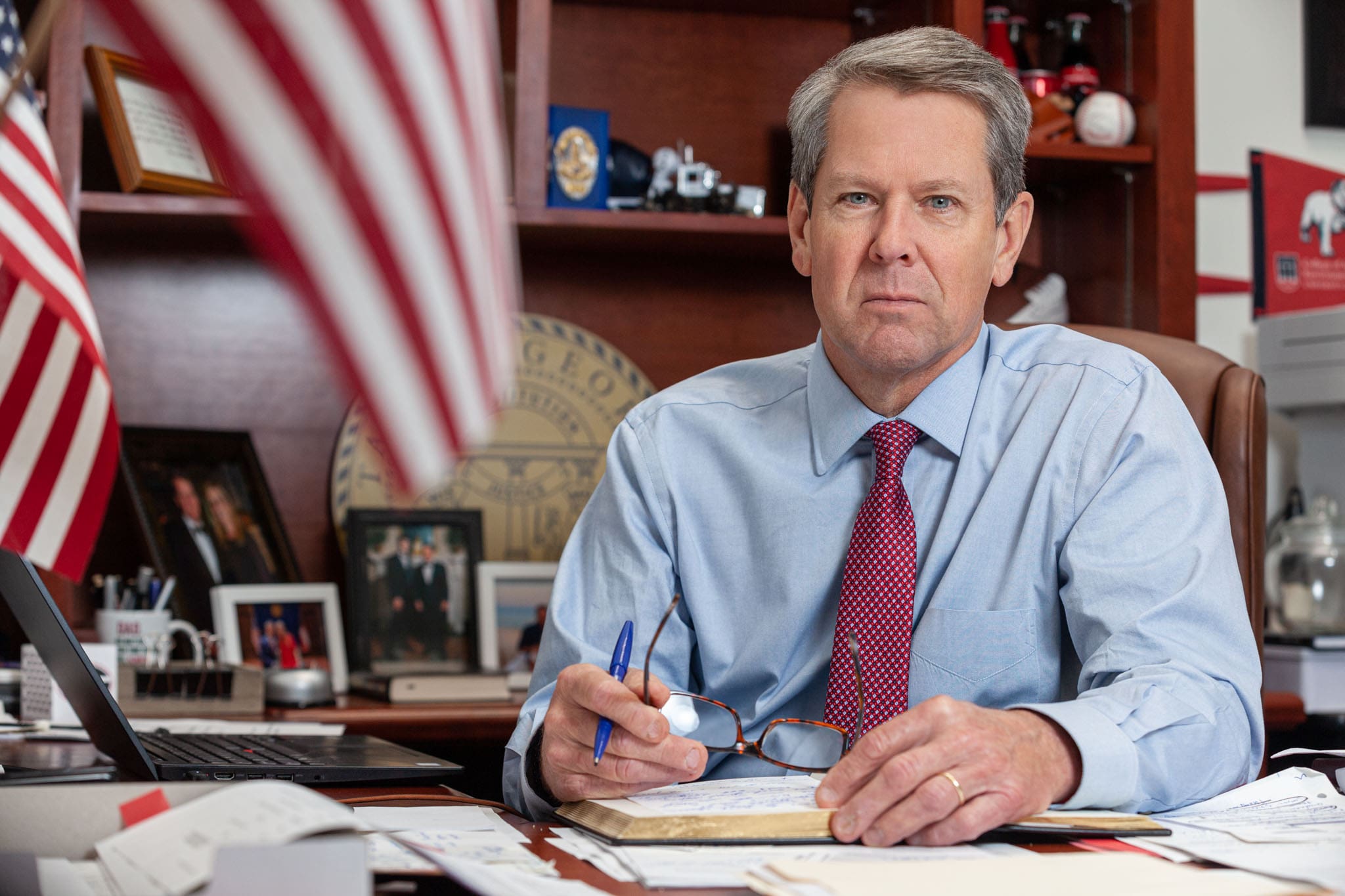 Georgia Governor Brian Kemp sitting at his desk in his office at the Georgia State Capitol.