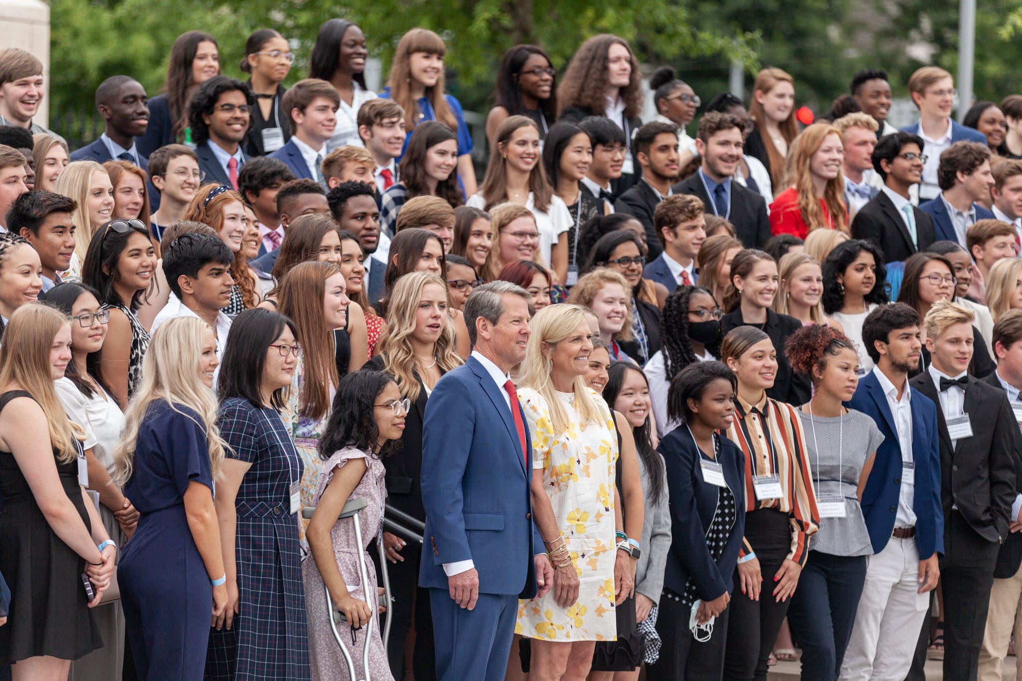 Georgia Governor Brian Kemp and First Lady Marty Kemp posing with hundreds of Georgia high school valedictorians in Liberty Plaza next to the Georgia State Capitol.