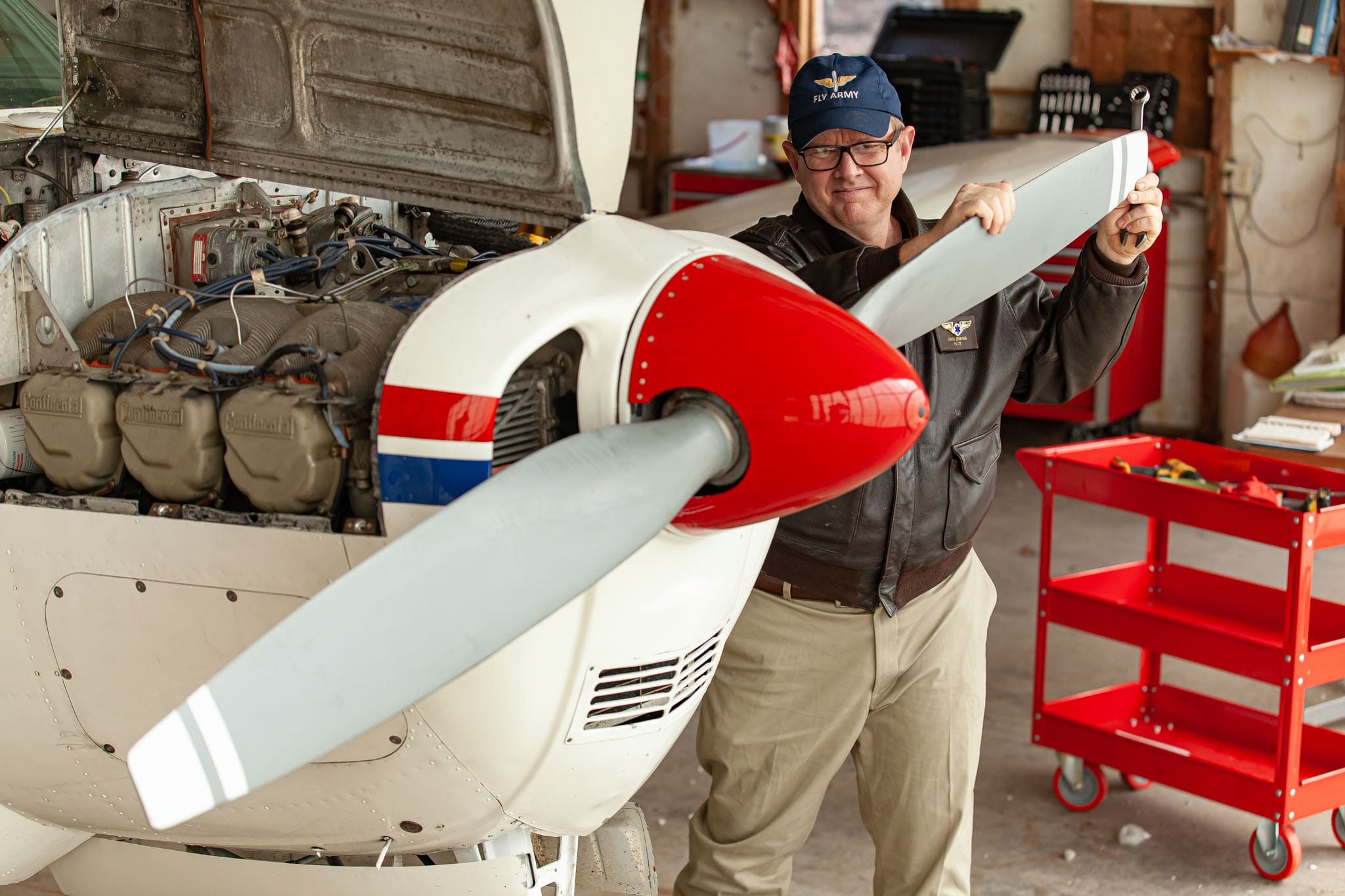 Georgia-State-Representative-and-helicopter-pilot-David-Jenkins-inspecting-his-airplane-engine-and-propeller.