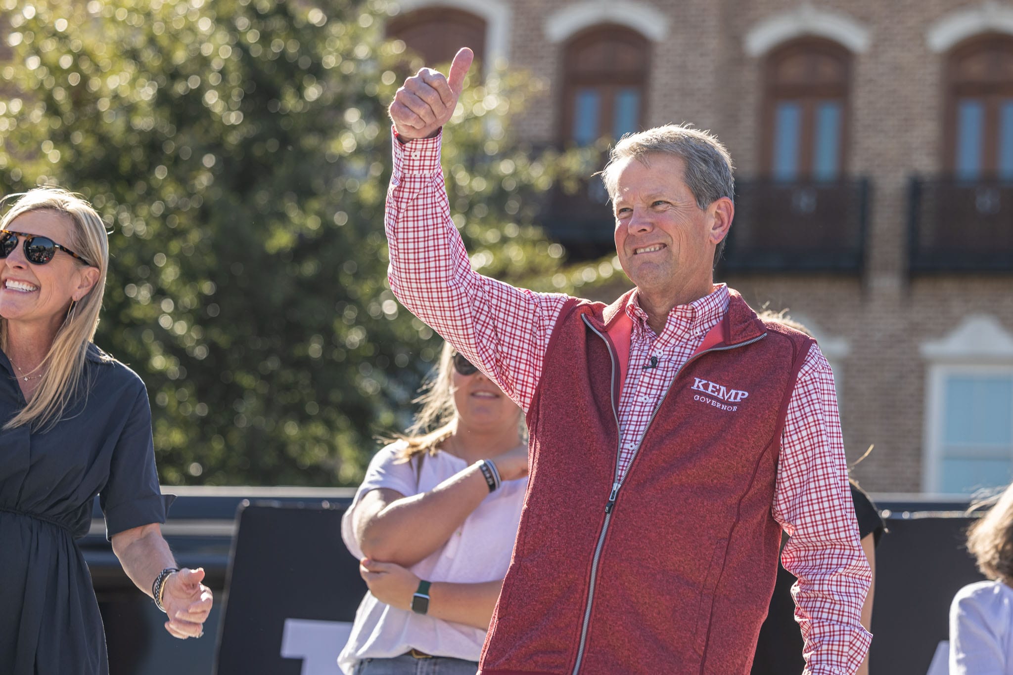 Elected-Georiga-governor-Brain-Kemp-holding-thumbs-up-at-crowd-of-people-in-rally-in-alpharetta-georgia