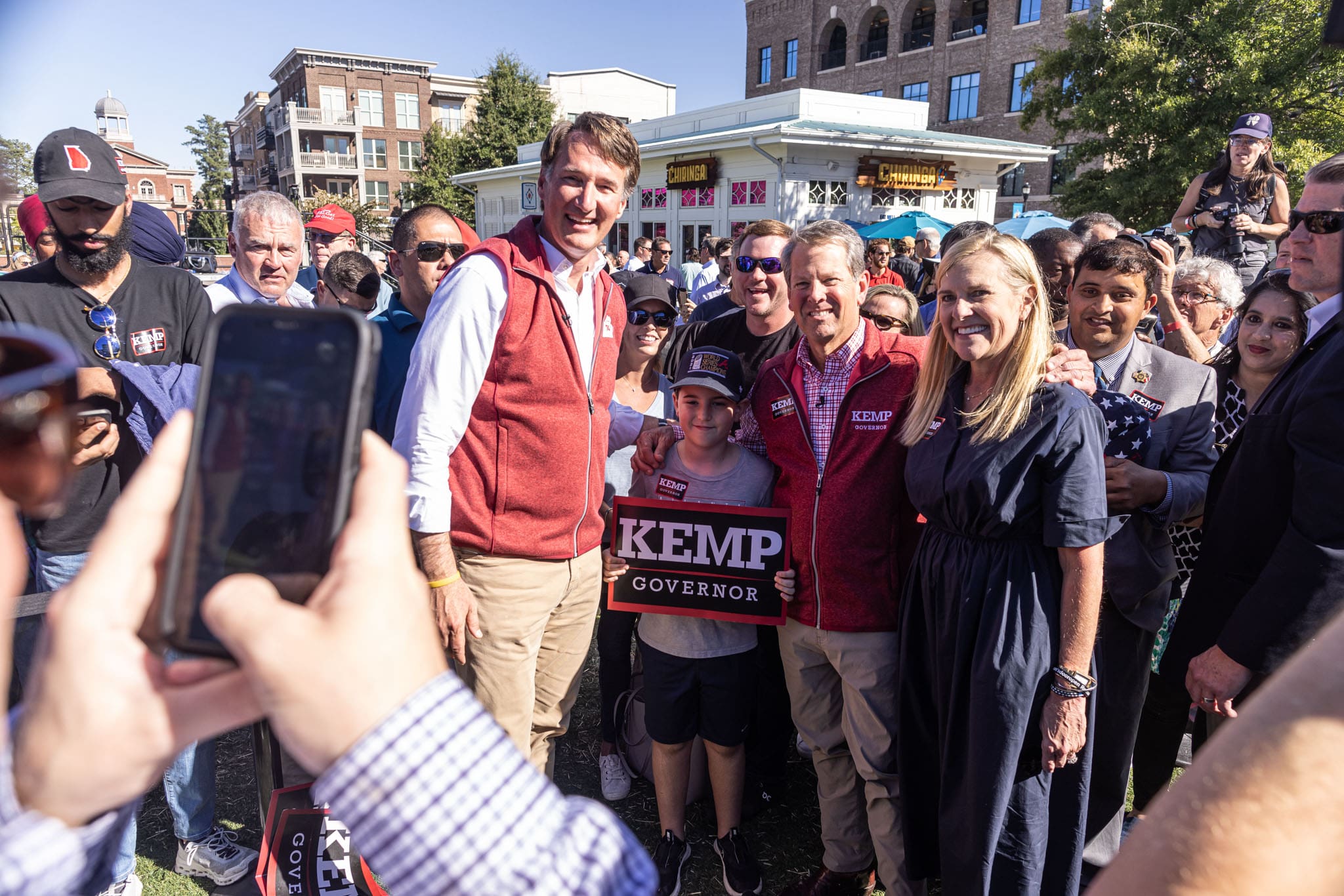 virginia-governor-glenn-youngkin-and-georgia-governor-brain-kemp-and-first-lady-marty-kemp-in-crowd-taking-pictures