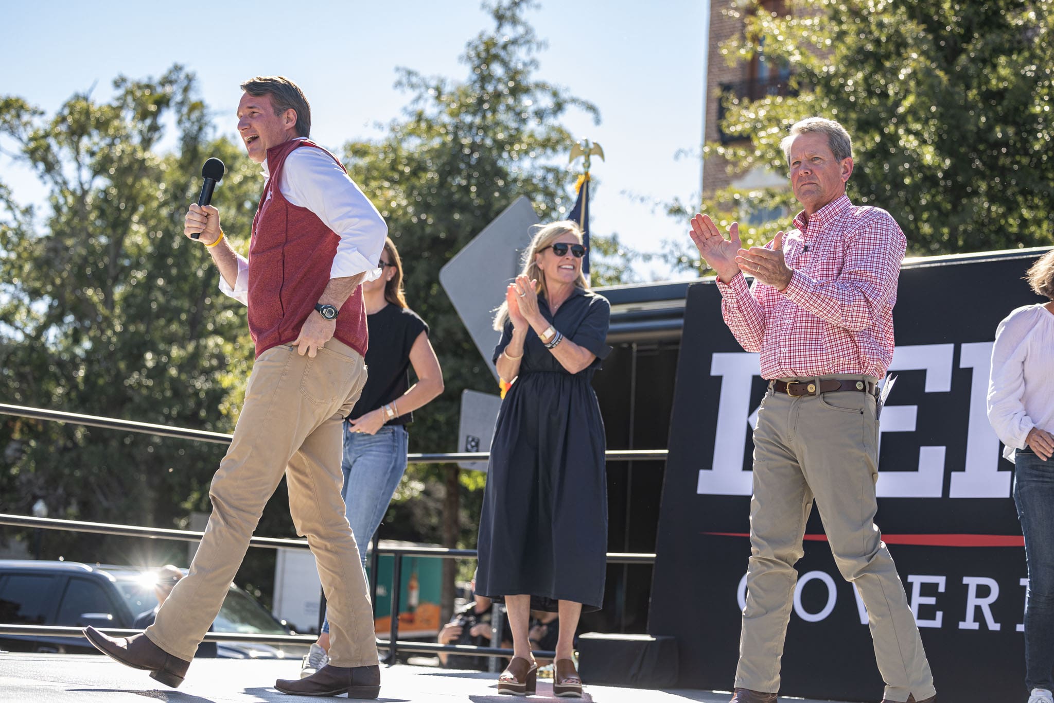 virginia-governor-glenn-youngkin-speaking-at-georgia-governor-kemp-rally-whilst-kemp-walking-from-behind-virginia-governor