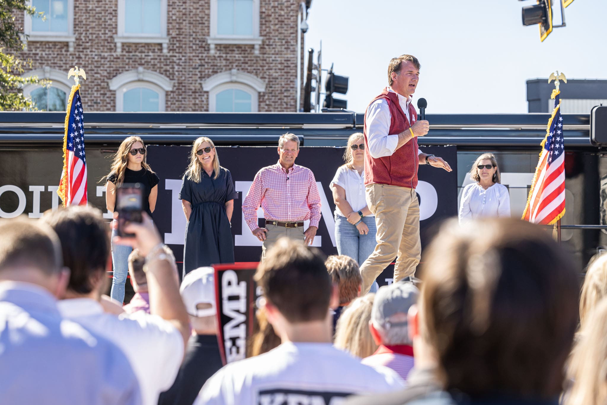 over-the-shoulder-shot-of-crowd-while-virginia-governor-glenn-youngkin-speaking-at-georgia-governor-kemp-rally