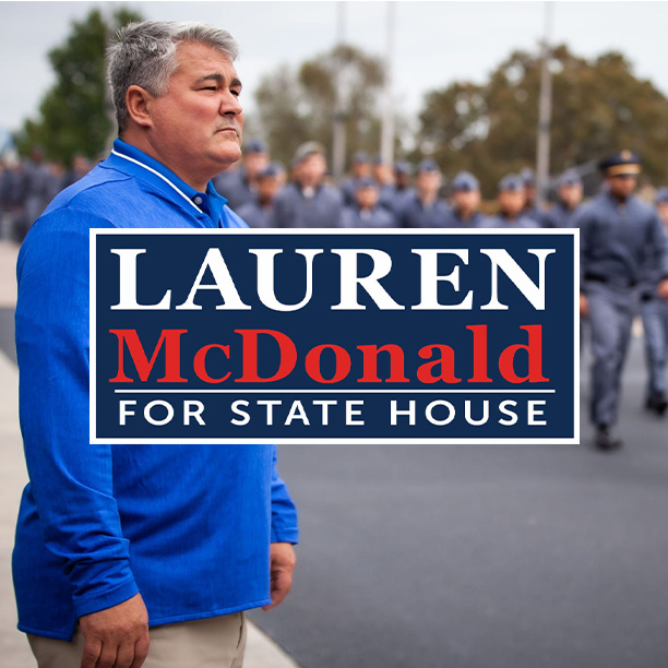 lauren-mcdonald-late-40s-male-facing-left-while-campaign-sign-is-centered-in-middle-as-riverside-cadets-and-commanders-march-in-formation