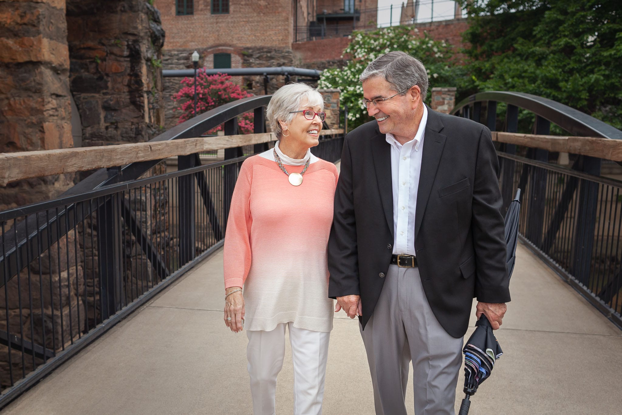 Georgia-State-Representative-Richard-Smith-and-wife-Clara-smiling-at-each-other-while-walking-on-a-bridge-in-Columbus-Georgia.