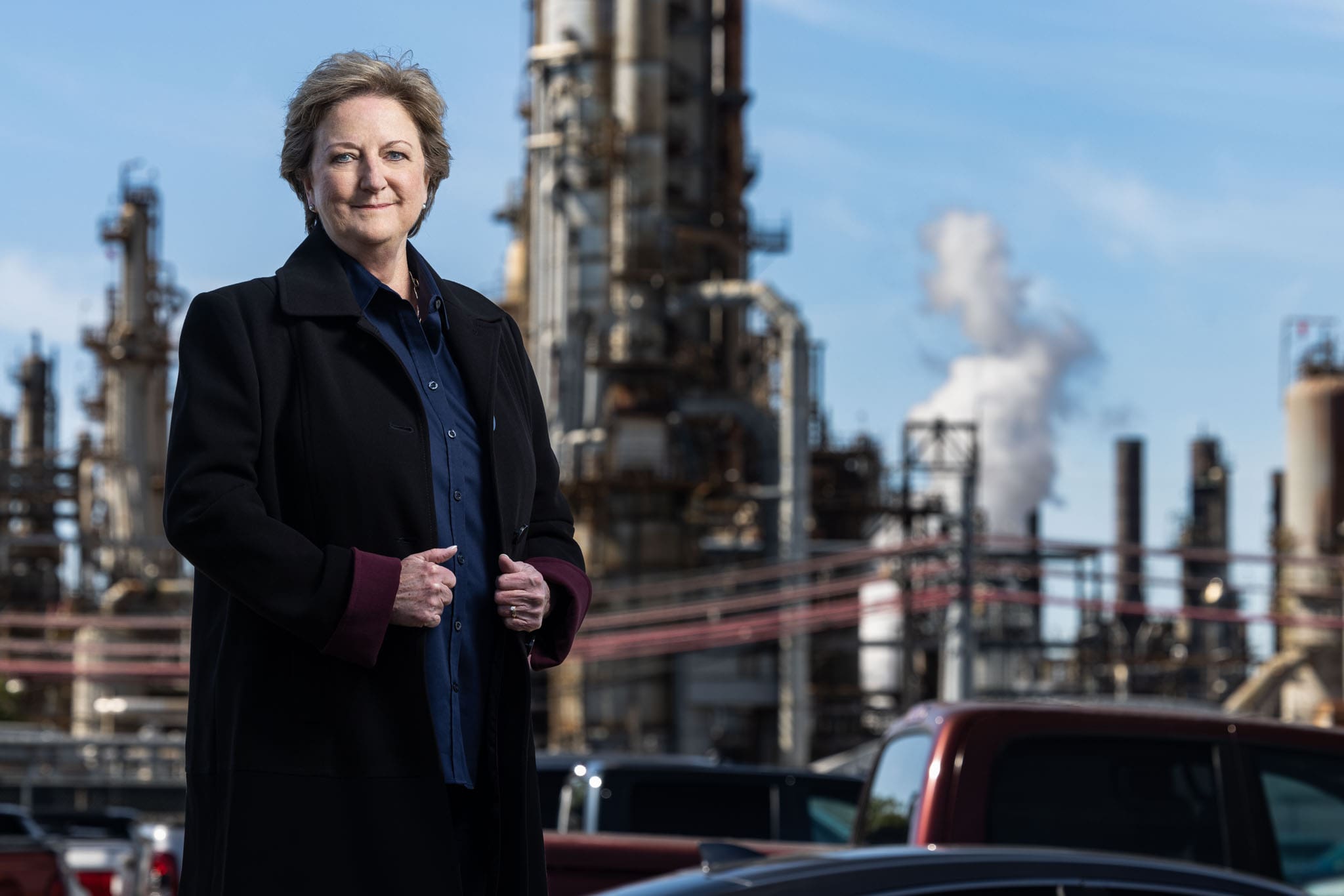 sharon-hewitt-mid-sixties-caucasian-woman-gazing-foward-with-oil-refinery-in-background