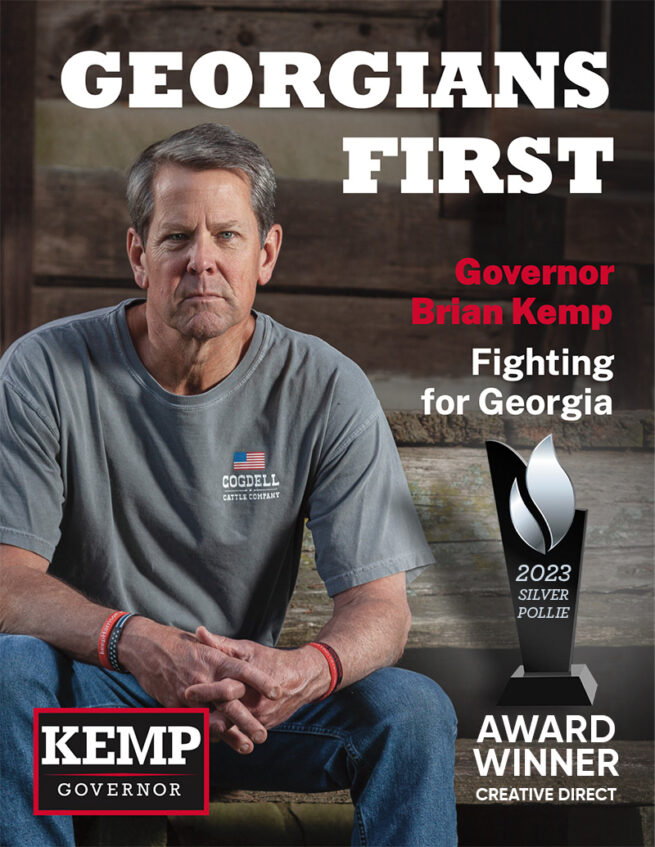 Elected-Georiga-governor-, Brain-Kemp-gazing-foward-whilst-sitting-on-stairs-of-log-cabin-with-2023-silver-pollie-trophy.