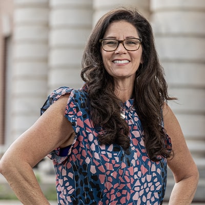 Vikki-Ford-caucasian-mid-40s-female-smiling-forward-in-front-of-courthouse